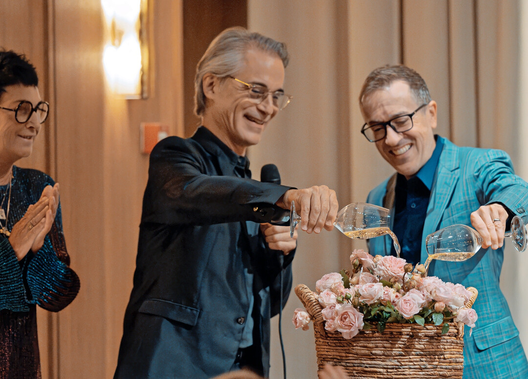 Niels Lan Doky and Geoffrey Keezer baptizing rose in champagne.