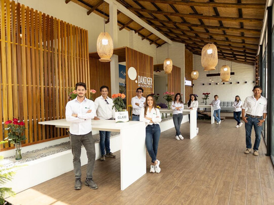 The facility encompasses a main house with dedicated spaces including a vase life room, meeting room, cold room, and an inviting display area for flowers, along with a reception area for gatherings. 