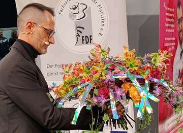 Alex Segura ties a colourful bouquet